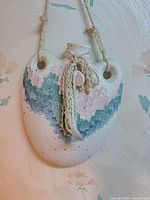 Front view of ceramic wall pocket hanging on wall
