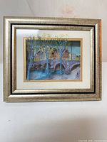 Front view of framed signed cityscape print