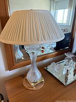 Full lamp showing shade, glass body, brass base