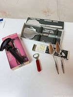 All four items grouped: boxed cranberry server, boxed corkscrew, boxed party servers, red-handled opener