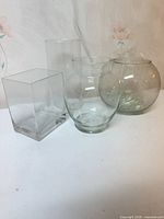 All four clear glass vases grouped together