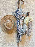Group shot showing straw hat and three umbrellas with sleeve
