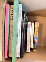 Spines of all nine books inside box