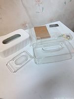 Group shot showing white tissue box cover, clear lucite box, clear tray with floral accent, cork pad, clipboard, soap dish