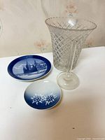 Overview of all four items: plate, dish, crystal vase, glass candlestick