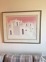 Full view of framed Southwestern adobe print above sofa