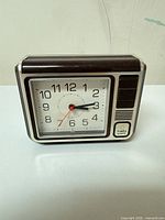 Front view of Timex brown and silver alarm desk clock
