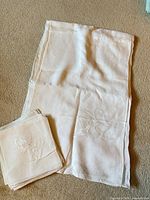 Full view of tablecloth and stack of napkins