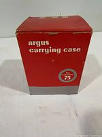 Argus red cardboard carrying case front