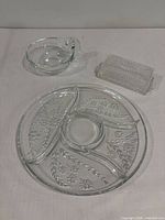 Group shot of round divided tray, sauce bowl, and butter dish with lid