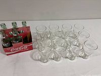 Lot overview showing 12 glasses, 5 bottles in red carrier