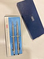 Pen and pencil inside open Cross box, lid alongside