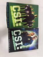 Front view of both Season 1 and Season 3 CSI DVD slipcases