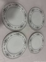 Overview of four matching porcelain dinner plates