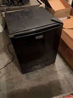 Closed black Emerson mini refrigerator showing exterior wear