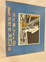 Full view of framed moon landing print with stamps