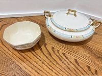 Lenox covered vegetable dish with lid and Homer Laughlin octagonal bowl on wooden surface