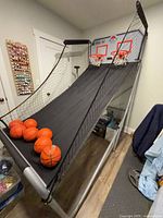 Full view of Lifetime Double Shot arcade game showing frame, return ramp, rims, nets, five of the mini basketballs, and upper netting