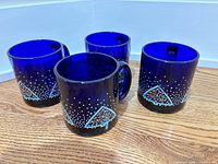Four cobalt blue Libby mugs with Christmas tree and speckle pattern