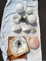 Group shot of all glass shades and hardware on cloth, shows size and condition