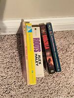 Spine view of all five paperback books standing upright