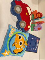 Group shot of car pillow, Nemo pillow and wooden book holder