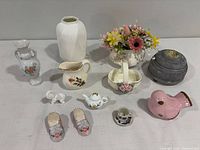 Group shot of all twelve porcelain and ceramic items