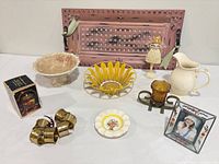 Group image showing brass napkin rings, porcelain dish and glass frame among other items