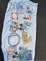 All items laid out including sealed shower kit, faucet, toilet kit, hoses, fittings