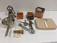 Group shot of all kitchen items including scale, juicer, saucepan, utensils and boxed parts