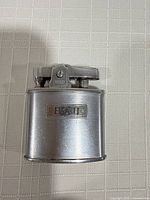 Front view of Ronson lighter showing engraved B&H plaque and chrome finish