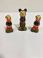 Front view of all three figurines standing upright