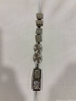 Full bracelet showing all seven decorative links in sequence