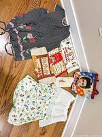 All items laid out showing aprons, towels and tote