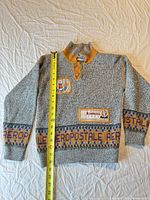 Full front view of Aeropostale kids sweater with measuring tape for scale