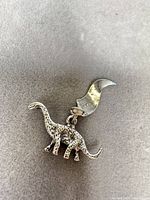 front view of sterling silver dinosaur charm with bail