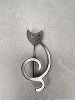 Full view of brooch front showing cat head and swirl body