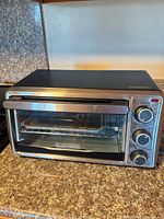 Front angled view of toaster oven showing exterior condition