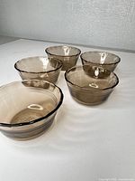 Group view of five amber glass bowls