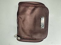 Closed brown nylon amenity pouch front view