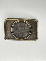 Full view of rectangular brass-tone belt buckle