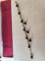 Full view of bracelet laid flat showing chain and bead charms