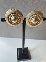 front view of both earrings on stand