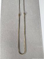 Full view of necklace laid flat showing overall design