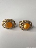 Front view of both cufflinks showing design and stones