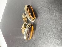 Front view of both cufflinks showing tiger’s eye cabochons