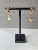 front view of both earrings on stand