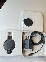 Full kit inside original box: Chromecast dongle, power adapter, USB cable, box pieces