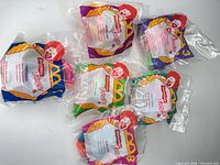 Six sealed Nickelodeon Tangle Twista-Zoid Happy Meal toys laid out