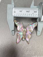 Pendant measured with caliper showing approx 35 mm height